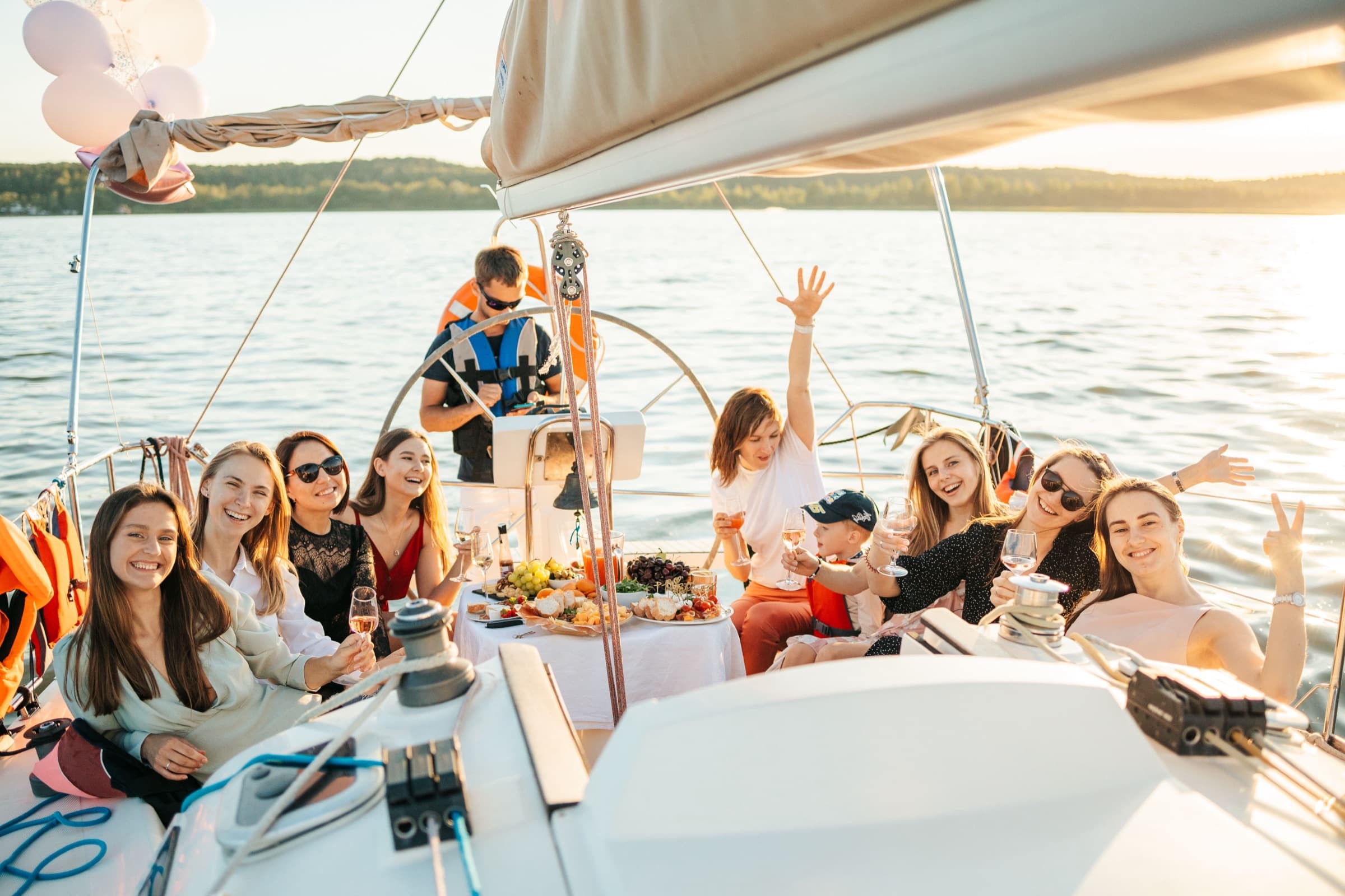 Friends entertaining on a yacht at sunset